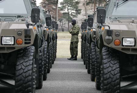 A Japan's Ground Self Defense Force (JGSDF) soldier is seen between rows of military vehicles before a ceremony to mark the launch of the Central Readiness Force at the JGSDF's Asaka Base, north of Tokyo, March 31, 2007. 