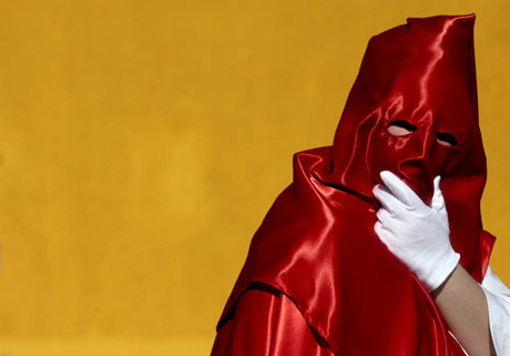 A penitent takes part in the procession of 'Cristo del Abandono' brotherhood during Holy Week in La Linea, southern Spain, April 4, 2007. Hundreds of Easter processions take place in Spain during Holy Week around the clock drawing thousands of visitors. 