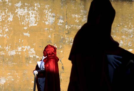 Penitents take part in the procession of 'Cristo del Abandono' brotherhood during Holy Week in La Linea, southern Spain, April 4, 2007. Hundreds of Easter processions take place in Spain during Holy Week around the clock drawing thousands of visitors. 