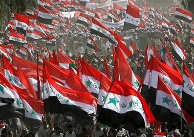 Followers of radical anti-US cleric Muqtada al-Sadr march through the holy city of Najaf, Iraq, Monday, April 9, 2007, on the fourth anniversary of the fall of Baghdad to the US forces. Tens of thousands draped themselves in Iraqi flags and marched through the streets of two Shiite holy cities Najaf and Kufa in a rally that was called for by al-Sadr who issued a statement ordering his militiamen to redouble their battle to oust American forces and argued that Iraq's army and police should join him in defeating 'your archenemy.'