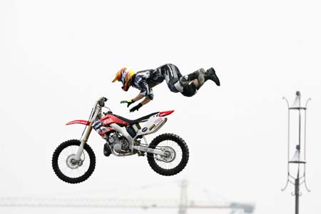 Robbie Aldaberd of Australia jumps with his motorcycle during a demonstration performance on the opening day of Asia Extreme Games in Shanghai May 3, 2007. 