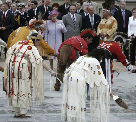 Britain's Queen Elizabeth II (6th R) and Prince Philip (4th R), Duke of Edinburgh, watch as native Americans dance at an arrival ceremony at the State Capitol Building in Richmond, Virginia, May 3, 2007. Virginia Governor Tim Kaine (5th R) is also pictured. It is the Queen's first visit to the United States in 16 years. 