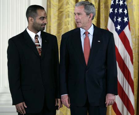 U.S. President George W. Bush (R) speaks to Student Body President of Virginia Tech Adeel Khan during the presentation of the President's Volunteer Service Awards at the White House in Washington May 10, 2007.