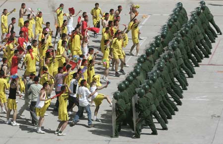 Paramilitary policemen take part in a drill preparing for football hooligans ahead of the Beijing 2008 Olympics at an army base in Beijing May 16, 2007.
