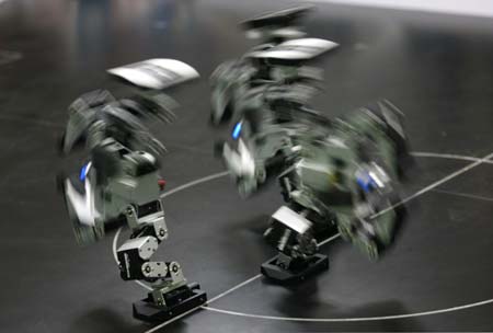 Robots, designed by Wuhan Institute of Technology team, perform during the 8th National Robot Soccer Competition in Wuhan, Central China's Hubei Province, May 15, 2007.The winners will represent China at the Federation of International Robot-soccer Association World Cup in San Francisco on June 13. [newsphoto]