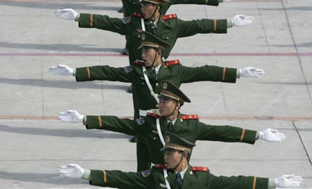 Paramilitary policemen practise gesture language during an exercise in preparation of the 2008 Beijing Olympics at an army base in Beijing May 16, 2007. 