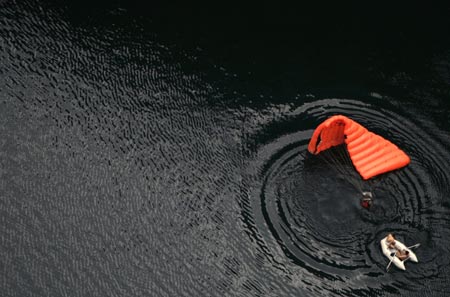 Base jumper Uros Ule of Slovenia floats in the water after he jumped from a 250 metre (820 feet) high cliff, near the southern town of Imotski, May 24, 2007. Ule was one of 6 international base jumpers who jumped into Red Lake without a permit from Croatian authorities. 