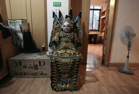 A performer waits backstage for the start of a Sichuan Opera show at the Jingjiang Theatre in Chengdu, southwest China's Sichuan province May 25, 2007. Sichuan Opera, which is distinguished by the face-changing technique where performers change masks in quick succession with a wave of the hand or by turning around, is one of the oldest forms of Chinese opera. 