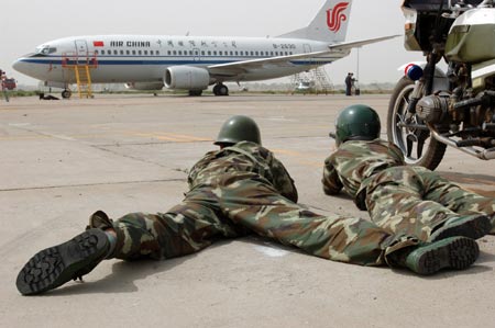 Chinese special policemen prepare to storm an aircraft during an anti-hijacking drill at an airport in Hohhot, North China's Inner Mongolia Autonomous Region, May 31, 2007. China is looking to establish an anti-terrorism legal framework and authorities are busy drafting a law to better combat terror threats, China Daily reported.