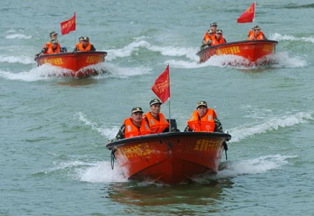 Chinese armed police conduct a search and rescue operation during a drill in Nanning, South China's Guangxi Zhuang Autonomous Region, June 4, 2007. The drill aimed to enhance the armed police' skills in fighting against the possible flood during the summer. Natural disasters including typhoons, floods and droughts killed 3,186 people in China in 2006, the death toll rising 28.7 percent on the previous year, Xinhua news agency reported in later May.[Xinhua]