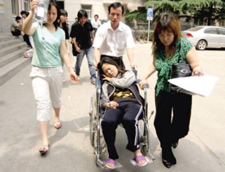 A student is wheeled into a hospital following a leakage of chemical products at a plant in Daxing District, Beijing, June 4, 2007. 38 students from a training school near the plant were hospitalized because of the irritant odor released by the chemical products, Beijing Times reported. [Beijing Times]