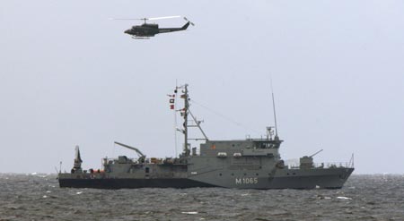 German naval vessel Dillingen, a mine hunter and a federal police helicopter patrol the Baltic sea side near the venue for the upcoming G8 summit in Heiligendamm June 3, 2007. The G8 summit which will be held at the Baltic seaside resort of Heiligendamm on June 6-8 in Germany. 