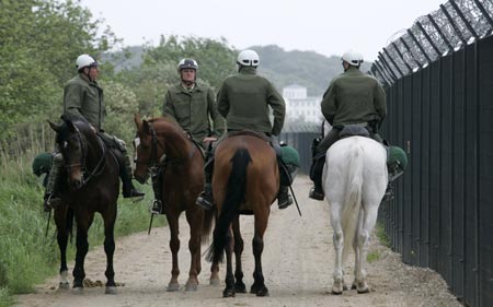 German mounted police patrol outside the security fence in front of the venue for the upcoming G8 summit at the eastern German Baltic Sea resort of Heiligendamm June 3, 2007. German police clashed with hundreds of protesters in the port of Rostock on June 2, 2007 following a much larger peaceful demonstration against next week's Group of Eight summit in the nearby Baltic resort of Heiligendamm, injuring several hundreds of police officers, police said.