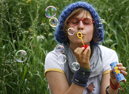 An anti-G8 demonstrator blows soap bubbles during a demonstration against the summit outside the airport Rostock-Laage prior to the arrival of U.S. President George W. Bush, June 5, 2007. The G8 summit will take place in Heiligendamm, about 20 kilometres southwest of Rostock from June 6 till 8. 