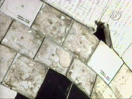 A torn insulation blanket (upper right) on the port side of the Shuttle Atlantis is shown in this video grab from the orbiter's end effector camera during a survey of the spacecraft's thermal protection system June 8, 2007. 