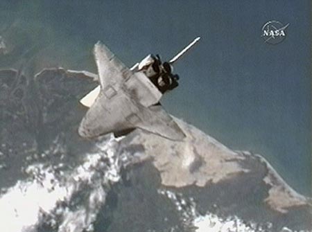 The Space Shuttle Atlantis performs a back-flip maneuver that will allow the Expedition 15 crew to photograph the shuttle's protective heat-resistant tiles in this view from NASA TV June 10, 2007. The imagery will be sent to engineers on Earth for analysis. [Reuters]