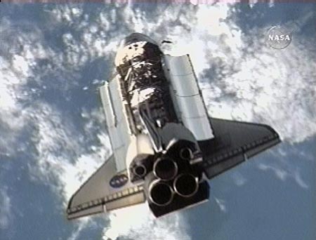 The Space Shuttle Atlantis completes a back-flip maneuver that will allow the Expedition 15 crew to photograph the shuttle's protective heat-resistant tiles in this view from NASA TV June 10, 2007. The imagery will be sent to engineers on Earth for analysis.[Reuters]