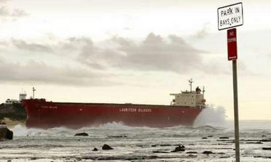 The 40,000 tonne coal ship Pasha Bulker sits about 100 metres (330 feet) off Nobbys Beach after running aground on Friday near the coal port of Newcastle on Australia's east coast June 9, 2007. Huge seas beached the Pasha Bulker in Australia on Friday, sparking a major rescue operation that saw all 22 crew members airlifted off the stricken vessel in gale force winds.