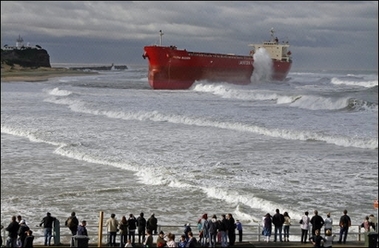 The 'Pasha Bulker' is stranded off Nobbys Beach in Newcastle. Rescue workers are urging thousands of people to evacuate their homes after deadly storms lashed Australia's east coast