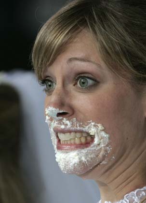 A contestant reacts after competing in the WE tv network's 'Bridezilla-Ultimate Cake Eating Contest' in New York's Times Square June 12, 2007. The cable channel gave away a $25,000 prize to kick off the fourth season of their 'Bridezillas' series. 