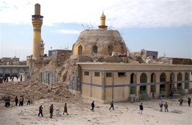 Iraqis walk past the damaged Askariya shrine following an explosion in Samarra, 95 kilometers (60 miles) north of Baghdad, in this Wednesday, Feb. 22, 2006 file photo. Insurgents blew up the two of the repaired shrine's minarets in Samarra, Wednesday, June 13, 2007. The Askariya shrine's dome was earlier destroyed on Feb. 22, 2006, in a bombing blamed on Sunni Muslim militants believed linked to al-Qaida that unleashed a wave of sectarian violence that continues to bloody Iraq.