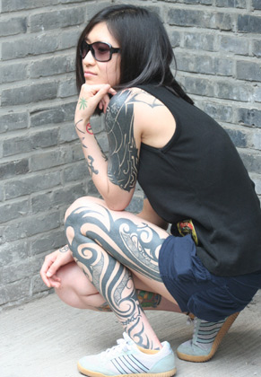 A girl shows her tattoos during the Tattoo Show Convention China 2007 in A girl shows her tattoos during the Tattoo Show Convention China 2007 in