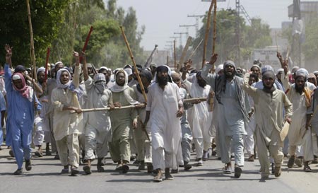 Islamic religious students protest in Multan against an assault by Pakistani forces on the Lal Masjid or Red Mosque in Islamabad July 10, 2007. Pakistani forces stormed a mosque compound on Tuesday, killing about 50 militants, as they fought their way through an Islamic school where they believed a rebel cleric was hiding with women and children hostages.