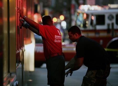 An unidentified man is stopped by undercover police officers on Third Avenue between 41st and 42nd Street near the scene of an explosion in New York, July 18, 2007. An underground steam pipe exploded in midtown Manhattan on Wednesday, shaking buildings, creating a towering geyser of debris and sending pedestrians fleeing in scenes reminiscent of the Sept. 11 attacks. [Reuters]
