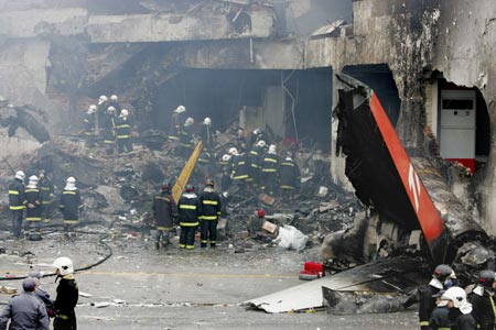 Firemen work to recover the victims of the crash of a TAM airlines Airbus A320 that slid off the runway of Congonhas airport and into a building before it exploded in fire, in Sao Paulo July 18, 2007. The Brazilian airliner crashed and burst into flames on Tuesday at Brazil's busiest airport, and as many as 200 people were feared dead in the country's second major air disaster in less than a year.