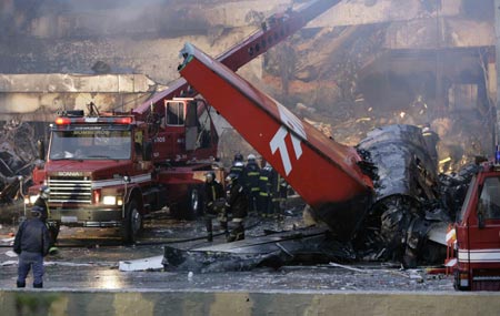 Firemen carry the body of a victim of the crash of a TAM airlines Airbus A320 that slid off the runway of Congonhas airport and into a building before it exploded in fire, in Sao Paulo July 18, 2007. The Brazilian airliner crashed and burst into flames on Tuesday at Brazil's busiest airport, and as many as 200 people were feared dead in the country's second major air disaster in less than a year.