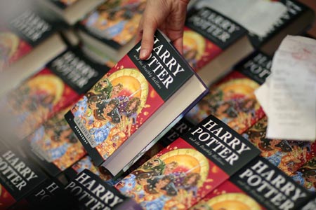 A bookseller holds a book at the German launch of J.K. Rowling's 