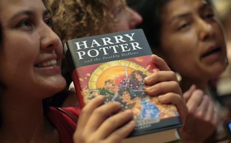 Fans of the Harry Potter book series pose for media at the start of the sales of J.K. Rowling's 