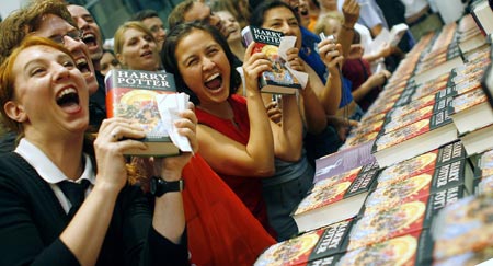 Fans of the Harry Potter book series pose for media at the start of the sales of J.K. Rowling's 