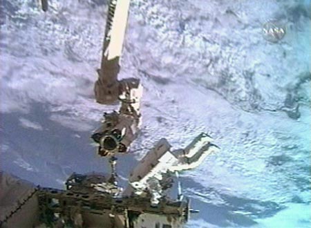 Flight engineer Clayton Anderson prepares to ride on the International Space Station's robot arm during a spacewalk July 23, 2007. The astronauts will install a television camera stanchion and jettison a 1,400-pound Early Ammonia Servicer during the planned 6 hour-plus spacewalk. 
