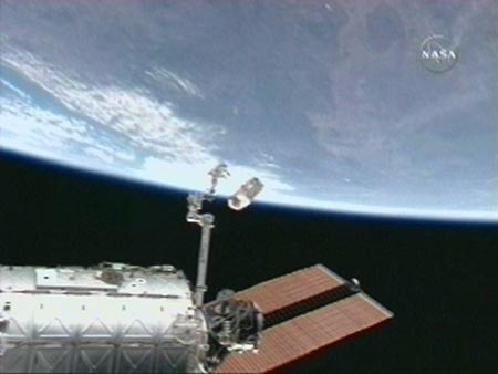 Flight engineer Clayton Anderson jettisons the refrigerator sized ammonia servicer unit into space from the end of the International Space Station's robot arm in this image from NASA TV July 23, 2007. 