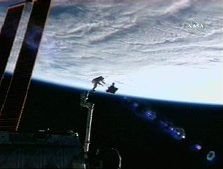Flight engineer Clayton Anderson jettisons the video stanchion frame while attached to the International Space Station's robot arm July 23, 2007. The spacewalking pair will install a televison camera stanchion and jettison a 1,400-pound Early Ammonia Servicer during the planned 6 hour-plus spacewalk. 