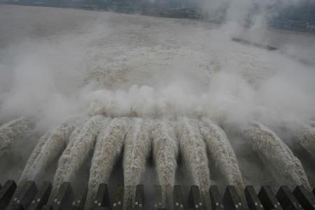Flood water is discharged through the sluice on the Three Gorges Dam July 22, 2007. The Three Gorges reservoir on Friday saw its highest flood peak this year, but with no disruption of operations, Xinhua reported. [newsphoto] 