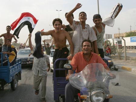 Residents celebrate the victory of Iraq's soccer team over South Korea during the semi-final of the 2007 AFC Asian Cup soccer tournament, in Kerbala, 110 km (68 miles) south of Baghdad, July 25, 2007. 