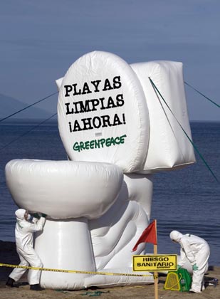 Greenpeace activists take part in a protest against the unloading of residual water into the sea and pollution of beaches at Los Muertos beach in Puerto Vallarta, Jalisco, August 1, 2007. The words on the blown up model of a toilet bowl reads, 