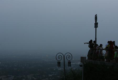 Visitors look out from the Daman-E-Koh viewpoint in Pakistan's capital Islamabad July 31, 2007. 