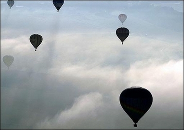 Hot air-balloons fly over a field near the Chambley-Bussieres air base, eastern France, during the 