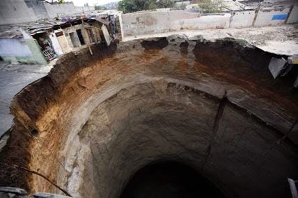 Giant hole swallows homes in Guatemala