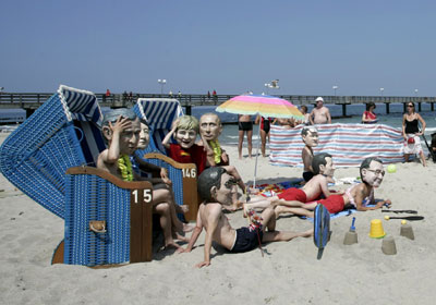 G8 'heads' gather on beach