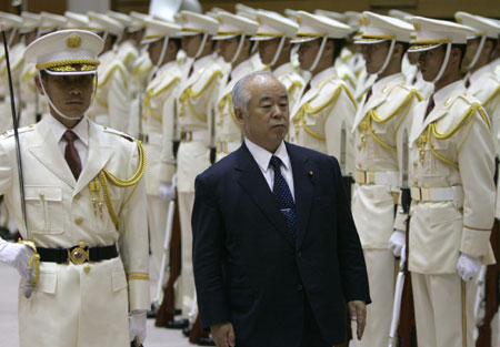 japan s defence minister fumio kyuma reviews a guard of honor at the ...