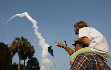 NASA guests watch the space shuttle Endeavour lifts off from launch pad 39A at the Kennedy Space Center in Cape Canaveral, Florida August 8, 2007. Endeavour blasted off on Wednesday for a construction mission to the International Space Station, carrying a former teacher who first trained for space flight with the ill-fated Challenger crew. 