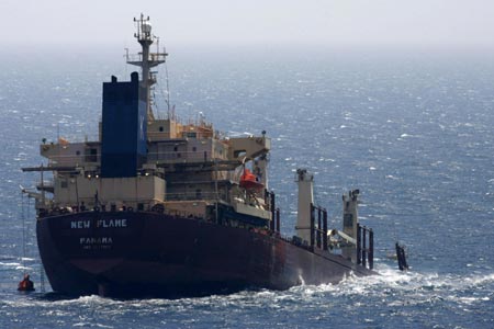 A cargo ship is seen semi-submerged after colliding with an oil tanker in the Strait of Gibraltar August 12, 2007. The ships collided early in the morning off Gibraltar damaging the cargo ship's bow. No injuries were reported.