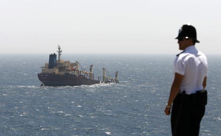 A cargo ship is seen semi-submerged after colliding with an oil tanker in the Strait of Gibraltar August 12, 2007. The ships collided early in the morning off Gibraltar damaging the cargo ship's bow. No injuries were reported. 