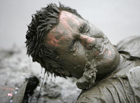 A reveller plays in the mud during the Sziget Music Festival on an island in Danube, Budapest August 12, 2007. The annual non-stop festival lasts for a week. 