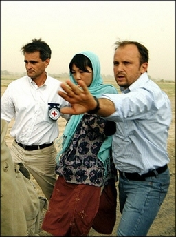 A man from ICRC puts his hand infront of the cameras in Ghazni as a South Korean hostages is freed by the Taliban. The Taliban has freed two South Korean female hostages in what they called a 'gesture of goodwill' towards talks to free the remaining 19 captured nearly a month ago.[AFP]