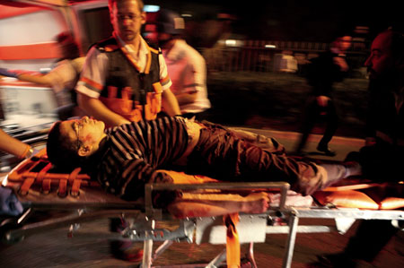 An injured Israeli youth is evacuated from the scene of a shooting attack in Jerusalem March 6, 2008. A Palestinian gunman opened fire in a Jewish religious school in Jerusalem on Thursday, killing at least eight people and wounding about 10 in the most lethal attack in Israel in two years, emergency services said. [Agencies]